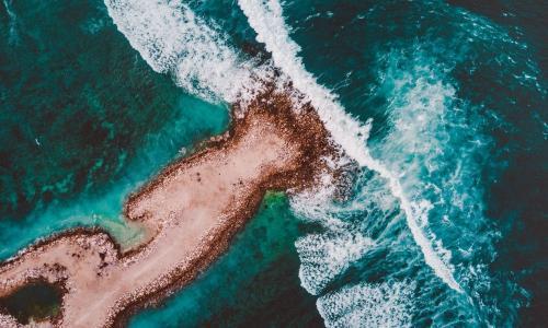 sand rock island deep green sea